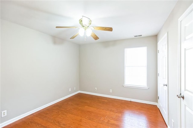 empty room with ceiling fan and wood-type flooring