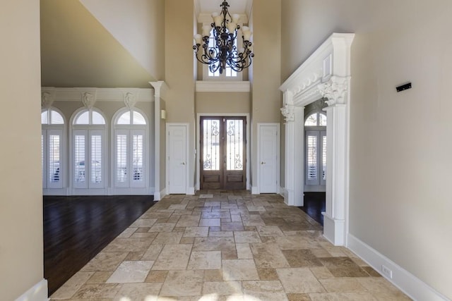 entrance foyer featuring a notable chandelier, french doors, and a high ceiling