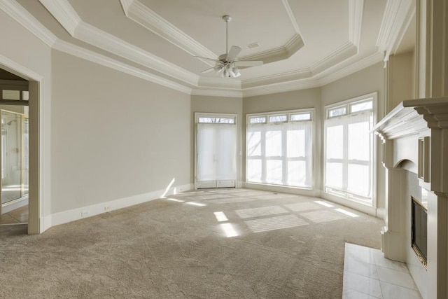 unfurnished living room with crown molding, light carpet, ceiling fan, and a tray ceiling