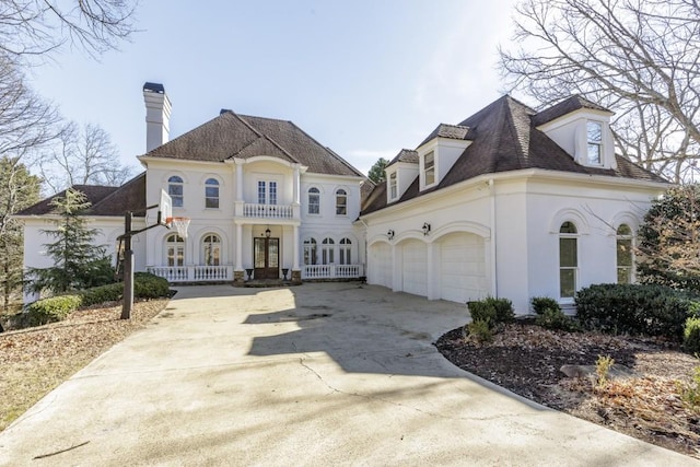 view of front of home with a garage and french doors