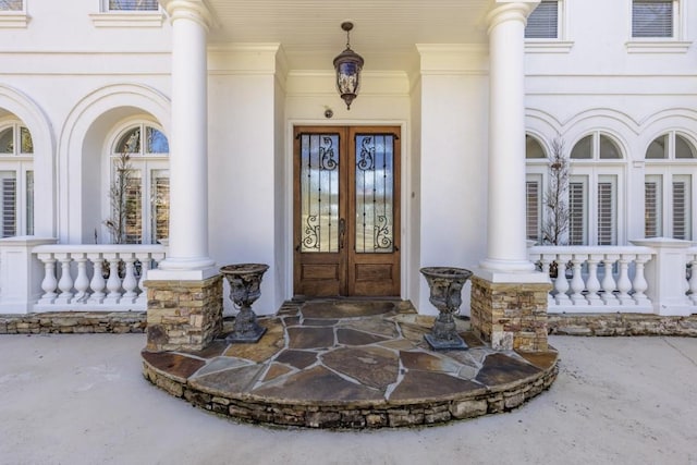 property entrance with a porch and french doors