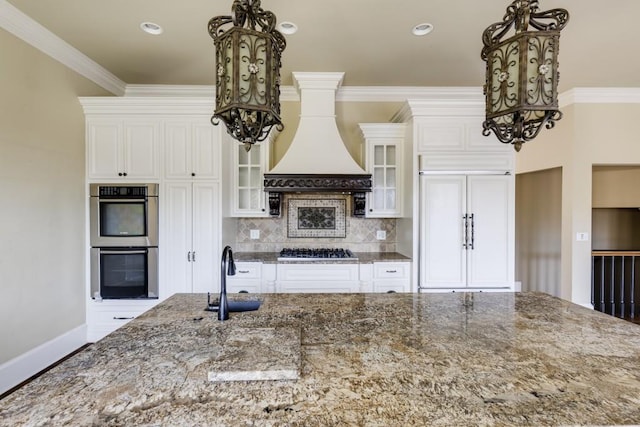 kitchen with stainless steel appliances, crown molding, sink, and dark stone counters