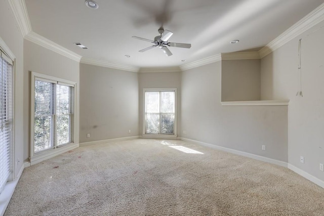 carpeted empty room featuring ornamental molding and ceiling fan