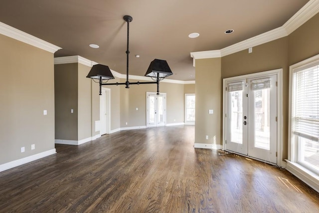 entrance foyer featuring french doors, crown molding, and dark hardwood / wood-style flooring