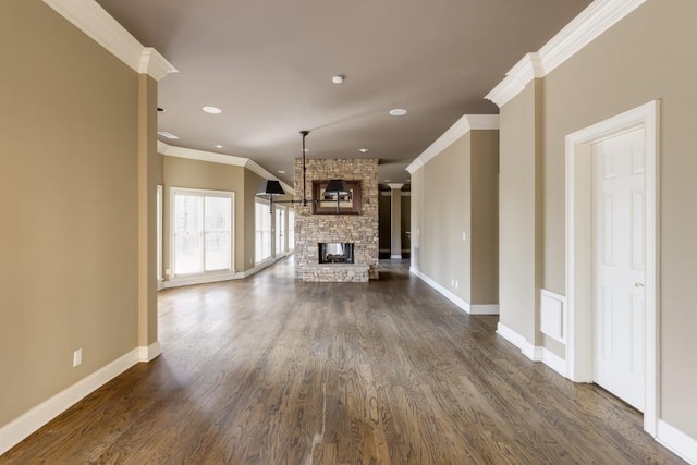 unfurnished living room featuring a fireplace, ornamental molding, and dark hardwood / wood-style floors