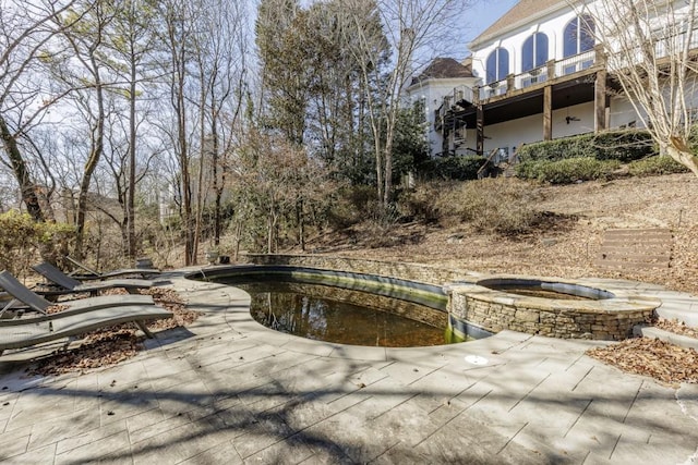 view of swimming pool featuring a patio and an in ground hot tub