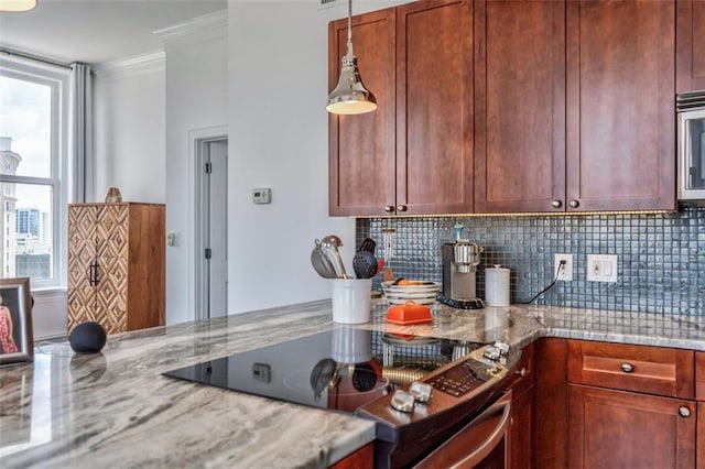57 Forsyth St NW Unit 12B, Atlanta, GA 30303 - kitchen with appliances with stainless steel finishes, ornamental molding, tasteful backsplash, light stone countertops, and hanging light fixtures
