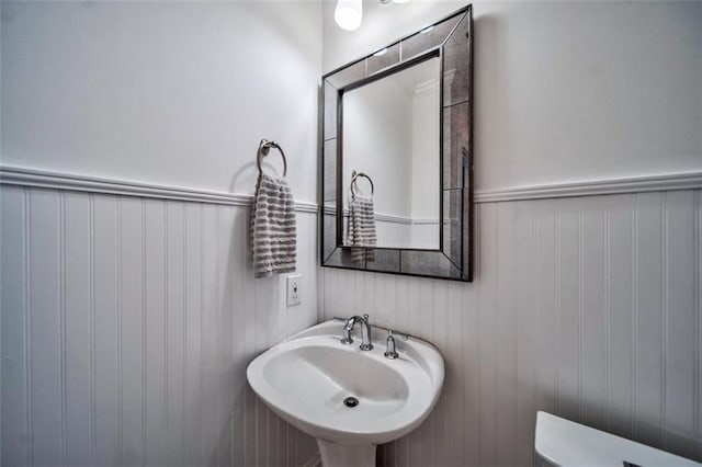 57 Forsyth St NW Unit 12B, Atlanta, GA 30303 - bathroom with a sink, toilet, and a wainscoted wall