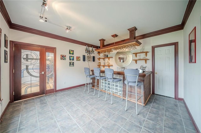 bar with crown molding, tile patterned flooring, and baseboards