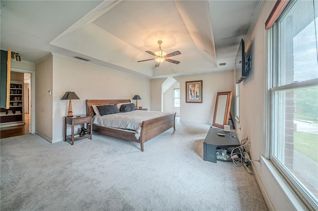 bedroom with baseboards, a raised ceiling, carpet flooring, and visible vents