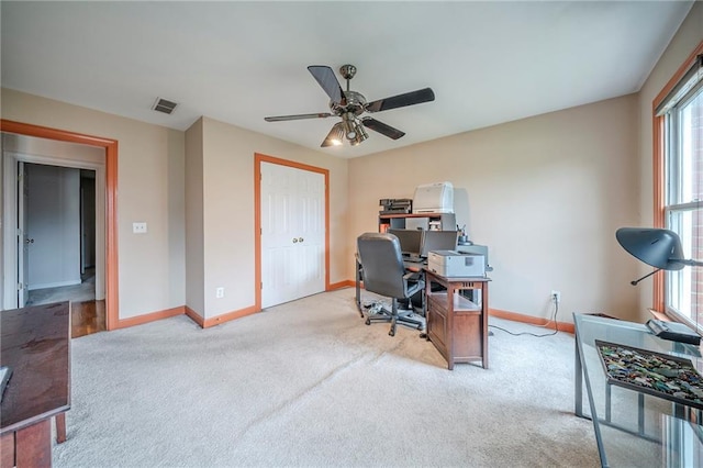 carpeted home office with baseboards, a healthy amount of sunlight, and ceiling fan