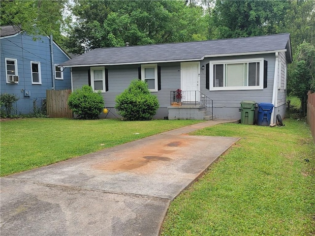 view of front of house with cooling unit and a front lawn