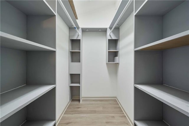 spacious closet featuring light hardwood / wood-style floors