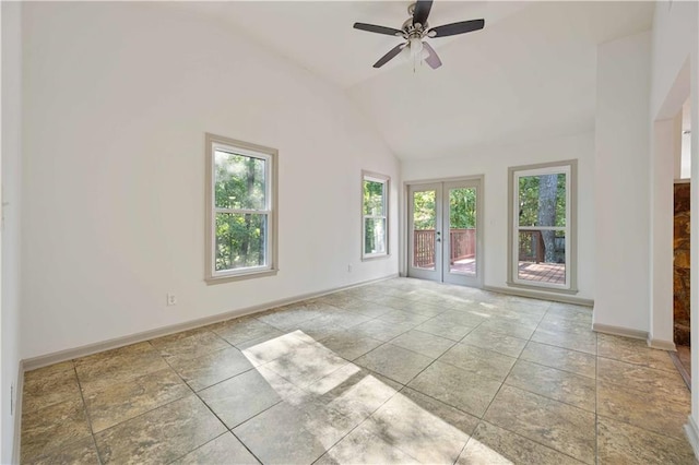 empty room with ceiling fan, vaulted ceiling, and french doors