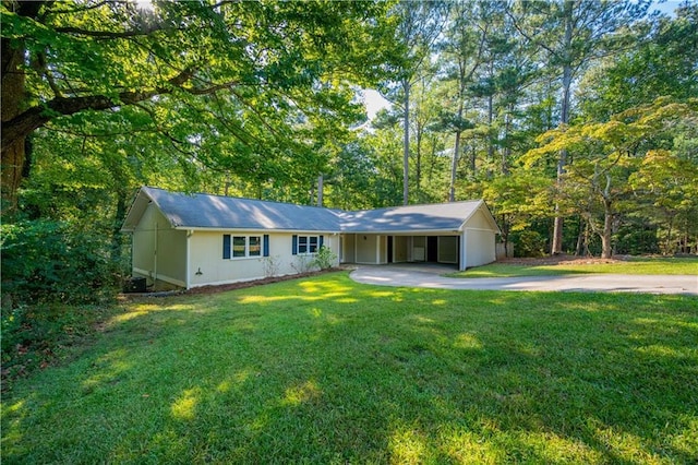 ranch-style house featuring a front yard and a carport