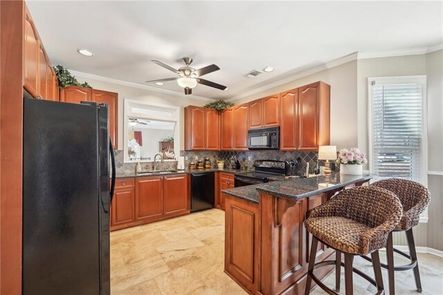 kitchen with sink, a breakfast bar area, kitchen peninsula, decorative backsplash, and black appliances