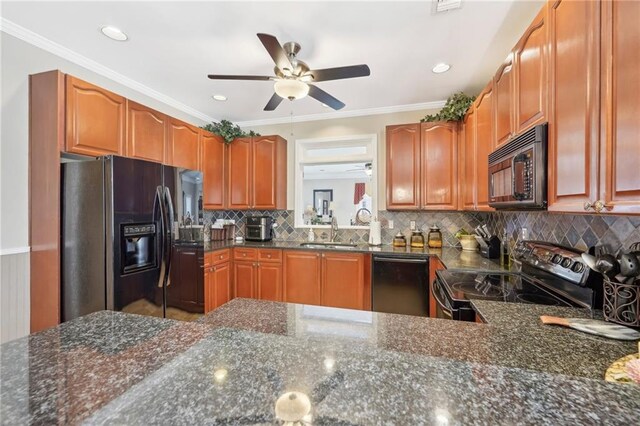 kitchen with tasteful backsplash, sink, dark stone countertops, black appliances, and crown molding