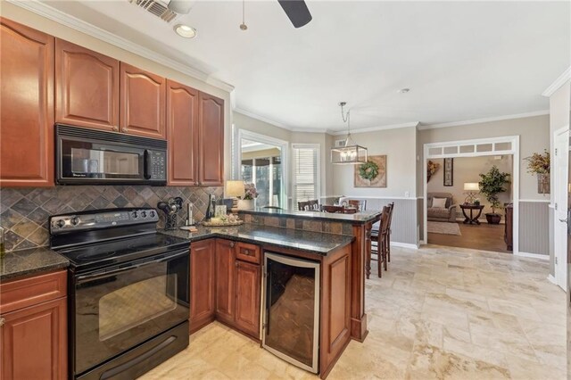 kitchen with decorative light fixtures, black appliances, beverage cooler, ornamental molding, and kitchen peninsula