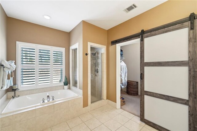 bathroom with tile patterned flooring and shower with separate bathtub