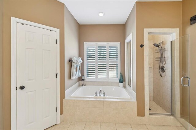 bathroom with tile patterned flooring and separate shower and tub