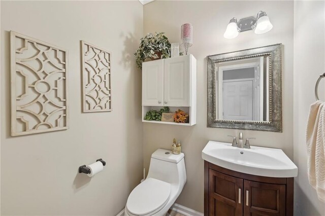 bathroom featuring vanity and toilet