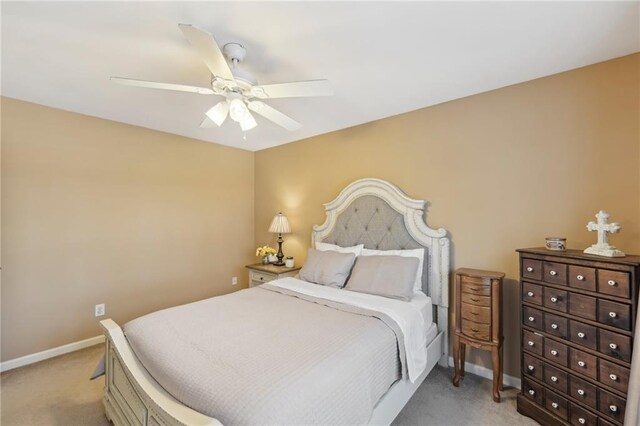 bedroom featuring light colored carpet and ceiling fan