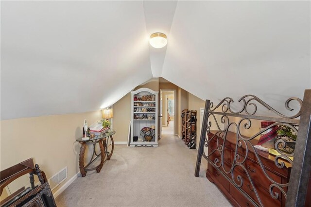 bonus room featuring light carpet and lofted ceiling