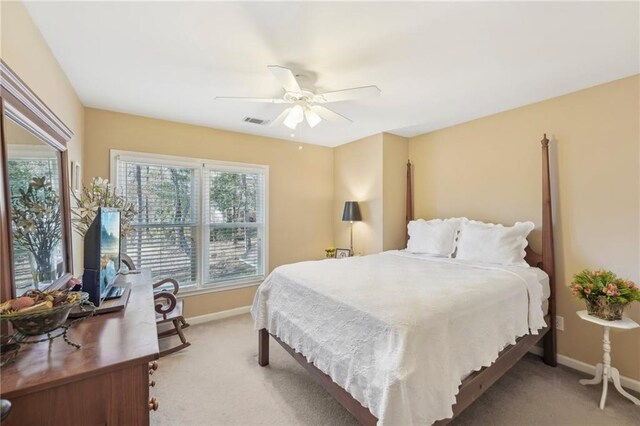 carpeted bedroom with ceiling fan