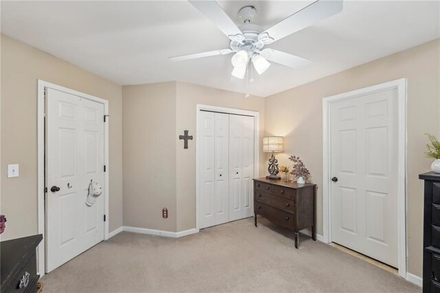 carpeted bedroom featuring a closet and ceiling fan