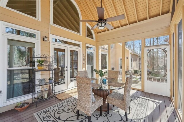 sunroom / solarium with vaulted ceiling with beams, a wealth of natural light, wooden ceiling, and french doors