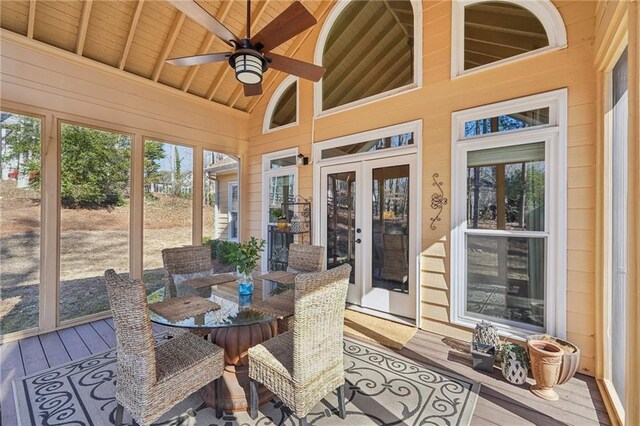 sunroom featuring ceiling fan, wooden ceiling, a healthy amount of sunlight, and vaulted ceiling with beams