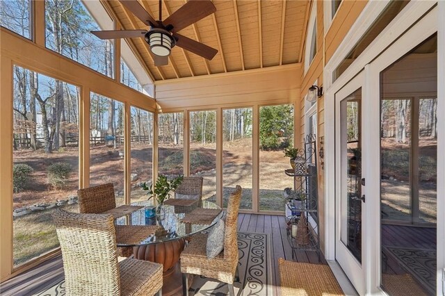 sunroom featuring lofted ceiling and ceiling fan