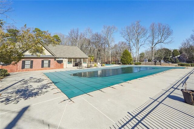 view of swimming pool with a patio area