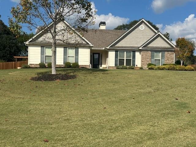 ranch-style home featuring a front yard