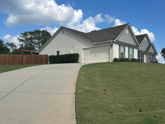 view of side of home with a garage and a lawn