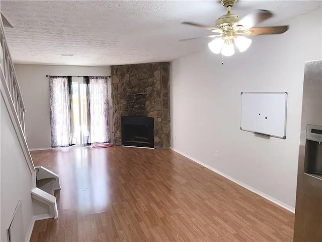6658 Ramsgate Way, Norcross, GA 30093 - unfurnished living room featuring wood finished floors, a ceiling fan, baseboards, and a textured ceiling