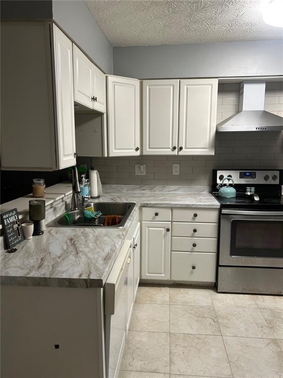 6658 Ramsgate Way, Norcross, GA 30093 - kitchen with wall chimney range hood, stainless steel range with electric stovetop, a sink, dishwashing machine, and white cabinets