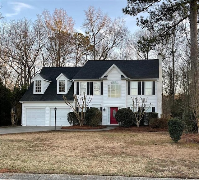 view of front of house featuring a garage and a front yard