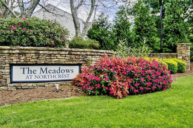 community / neighborhood sign with a yard