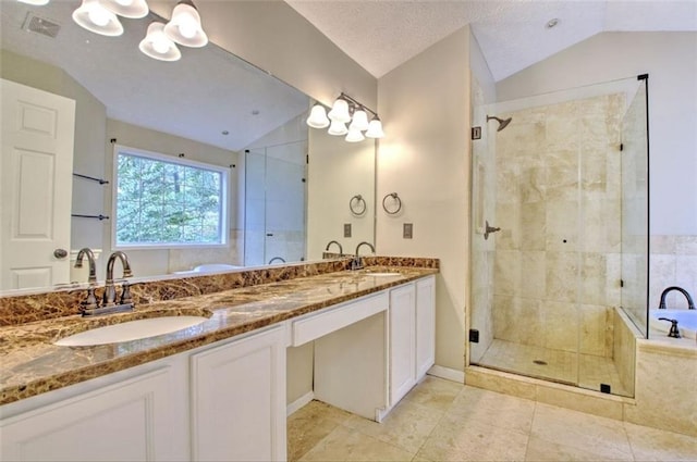 bathroom featuring vanity, vaulted ceiling, and separate shower and tub