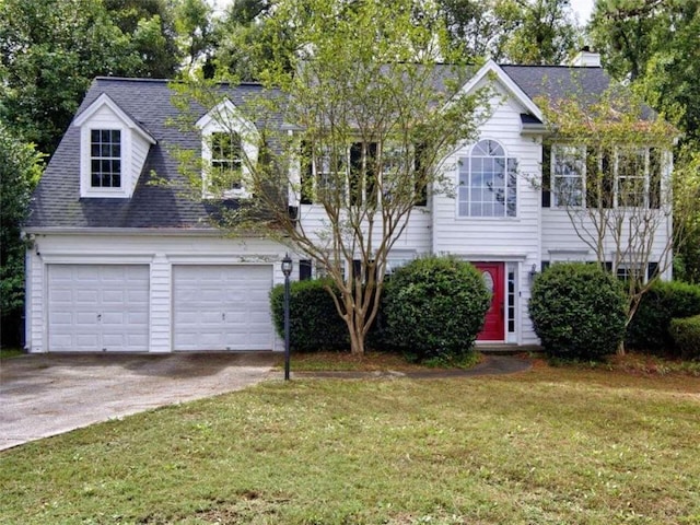 view of front of home with a garage and a front yard