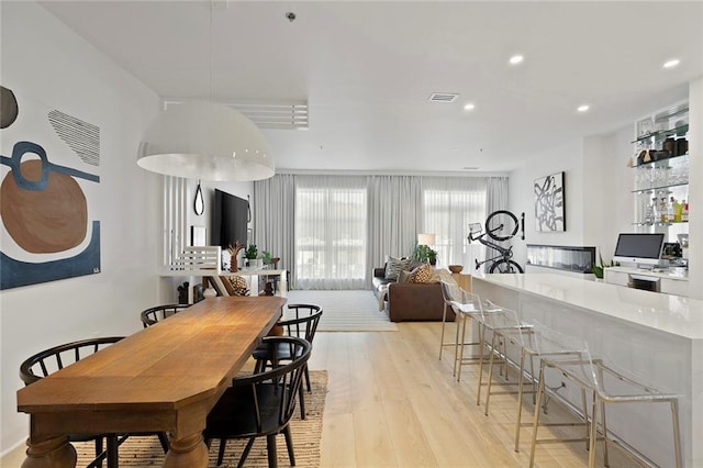 dining space with light hardwood / wood-style flooring