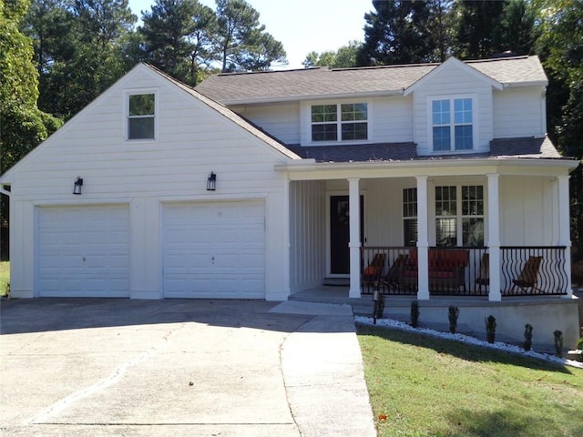 view of front of home with covered porch, a front lawn, and a garage