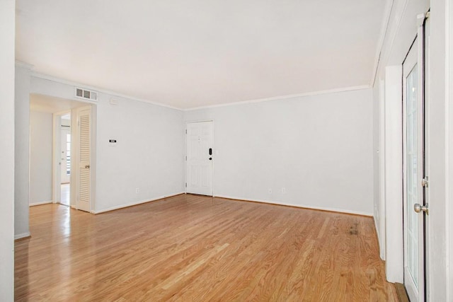 1445 Monroe Dr NE Unit F10, Atlanta, GA 30324 - empty room featuring ornamental molding, light wood finished floors, and baseboards