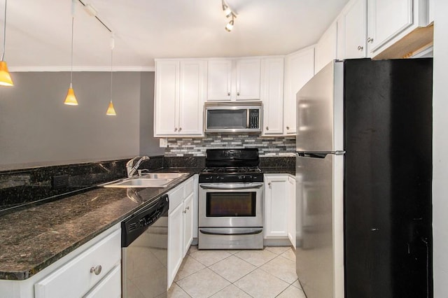 1445 Monroe Dr NE Unit F10, Atlanta, GA 30324 - kitchen featuring appliances with stainless steel finishes, rail lighting, a sink, light tile patterned floors, and white cabinetry