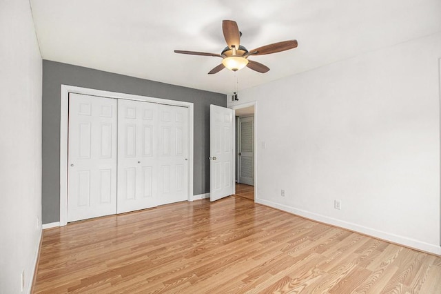 1445 Monroe Dr NE Unit F10, Atlanta, GA 30324 - unfurnished bedroom with light wood-style floors, baseboards, a closet, and ceiling fan