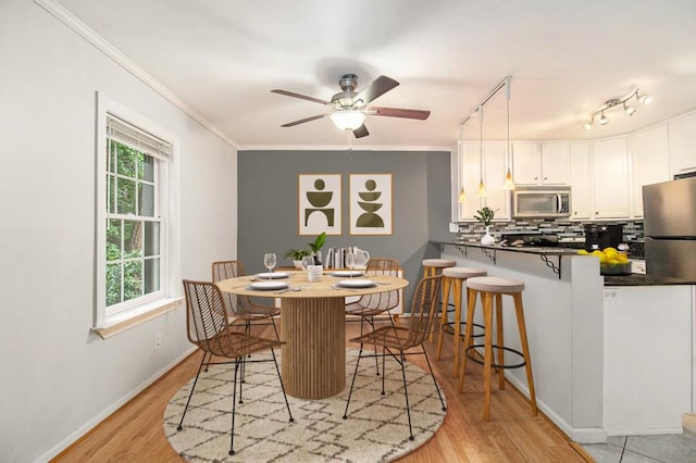 1445 Monroe Dr NE Unit F10, Atlanta, GA 30324 - dining room with light wood-style flooring, healthy amount of natural light, ornamental molding, baseboards, and a ceiling fan