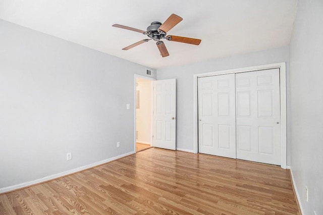 1445 Monroe Dr NE Unit F10, Atlanta, GA 30324 - unfurnished bedroom featuring light wood finished floors, baseboards, and a closet