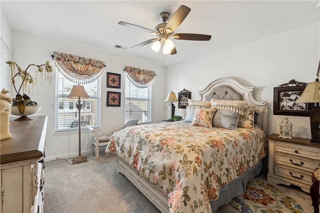 bedroom featuring ceiling fan, carpet, visible vents, and baseboards