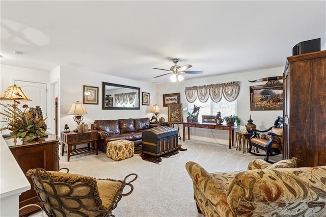 living area with light carpet and ceiling fan